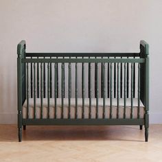 a green crib in front of a white wall