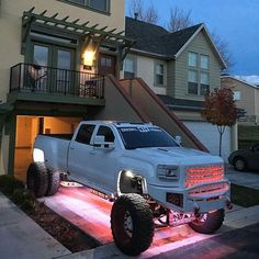 a large white truck parked in front of a house