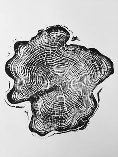 a piece of wood that has been cut in half and is being drawn with black ink