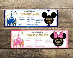 two disney land tickets sitting on top of a wooden table