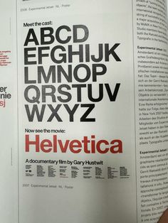 an open book with the words helvetica written in black and red on it