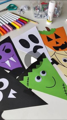 halloween crafts and supplies on a table with markers, crayons, pencils