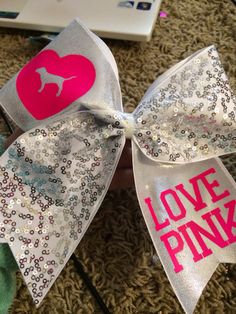 a bow with the word love pink on it and an image of a dog's head