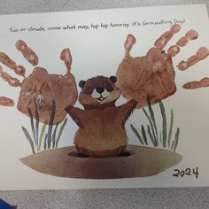 a card with an image of a beaver and handprints for someone's birthday