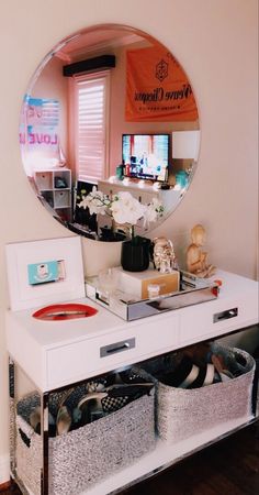 a mirror sitting on top of a white dresser