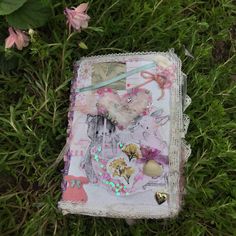 an altered book is laying on the grass