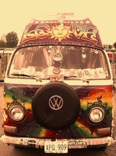 an old vw bus painted in rainbow colors