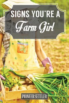 a woman holding a box full of vegetables and the words signs you're a farm girl