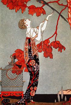 a woman is holding a bird in her hand while standing under a tree with red flowers