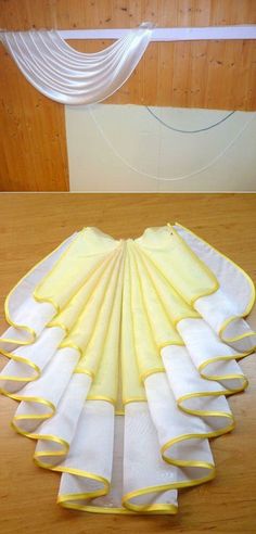 a table topped with lots of white and yellow napkins