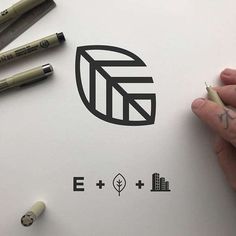 a hand is holding a pen over a piece of paper with the letters e and f on it