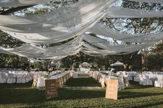 an outdoor wedding setup with white draping