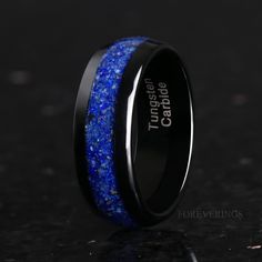 ►Material: Tungsten Carbide and Crushed Lapis Lazuli ►Color: Black ►Comfort Fit ►Band width: 8mm ►Fit is true to size. ►This hand-crafted tungsten ring features an inlay of crushed Lapis Lazuli. Its deep, celestial blue will stand out amongst the crowd of standard wedding bands. ►Your crushed Lapis Lazuli inlay is protected with a coating that defends it from water, dirt, and grime. ►Lapis Lazuli symbolizes royalty and honor. ►This hand crafted tungsten ring features polished tungsten. Having an Lapis Lazuli Wedding Ring, Round Tungsten Carbide Jewelry Gift, Round Tungsten Carbide Promise Ring Jewelry, Tungsten Carbide Promise Ring, Lapis Lazuli Wedding Band, Lapis Lazuli Mens Ring, Luxury Lapis Lazuli Ring Jewelry, Black Tungsten Mens Rings, Luxury Lapis Lazuli Gift Ring