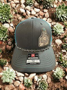 Welcome to DMDesignsPlus Etsy store! We sell a variety of handmade and personalized items perfect for holiday gifts, party stuffers, and more!  Product Information: Richardson 112 SnapBack Hat with Charcoal Grey/Teal Coloring, White tooled vegan leather patch with faux turquoise accents, Western Hat Richardson 112 SnapBack Hat---Charcoal Grey/Teal. White tooled vegan leather patch with faux turquoise accents.  Includes barbed wire removable hat chain.  Thank you for shopping small! Please remember to leave a review. It helps us a lot! Leather Hat Patch Ideas, Western Trucker Hats, Leather Hat Patch, Trucker Hat Outfit, Country Outfitter Boots, Hat Chain, Custom Baseball Hats, Funny Trucker Hat, Men's Hipster Style