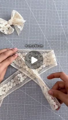 someone is cutting out lace with scissors on a piece of fabric that has been cut into smaller pieces