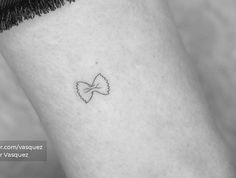 a small tattoo on the ankle of a woman's left leg, with a heart in the middle