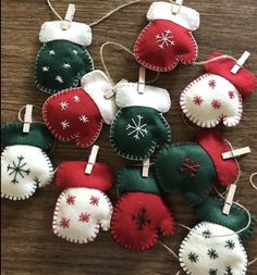 christmas ornaments hanging from clothes pins on a table