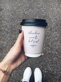 someone holding up a coffee cup with the words adventure awaits but forget