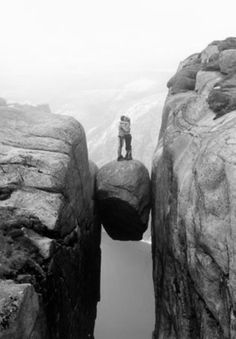 a person standing on top of a rock formation