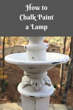 a white painted bird bath with the words how to chalk paint a lamp on it