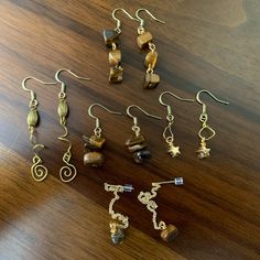 Various golden dangly earrings on copper fish hooks. Swirl Star, Fish Hooks, Dangly Earrings, 8th Grade, Tigers Eye, Tiger's Eye, Tiger Eye, Tigers, Labour Day