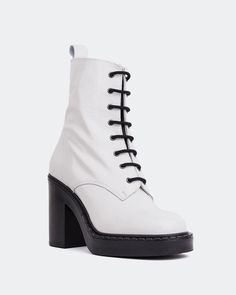 a white boot with black laces on the side and heeled boots at the bottom