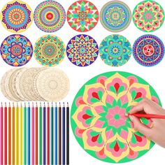 a person is drawing with colored pencils next to several circular designs on the paper