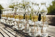 an assortment of wine glasses sitting on top of a wooden table next to each other