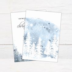 two cards with trees and snow on them