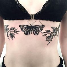 a woman with a butterfly tattoo on her stomach