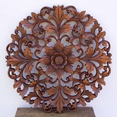 an intricately carved wooden object on a pedestal