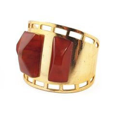 Description: Vintage cuff with a three piece bakelite on gold toned metal.Colour: Cherry Amber tonedDimensions: Height: 4.5cmDiametre: 4.5cm Materials: Bakelite, metal. Era: 1950'sCondition: Excellent Vintage Gold Cuff Jewelry, Formal Brass Cuff Jewelry, Gold Modernist Cuff Bracelet For Formal Occasions, Formal Polished Brass Cuff Bracelet, Vintage Brass Cuff Jewelry, Vintage Brass Cuff Bracelet For Formal Occasions, Vintage Cuff Bangle With Polished Finish, Modernist Brass Jewelry For Formal Occasions, Elegant Bakelite Bracelet Jewelry