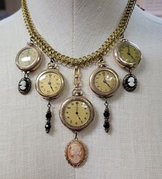 PLEASE READ DESCRIPTION... WATCHES DO NOT WORK Five gorgeous round vintage watches steal the show in this unique creation. Each one is a work of art. Even though they no longer work to keep time, they are timeless treasures... I love the combination of the unique gold chains, the watches, cameos, and black beaded charms. I'll just let the photos speak for themselves... Two of the watches are engraved on the back. They can be turned to show the engravings and give the necklace an entirely differnet look (See photos). This is definitely a one-of-a-kind design that will turn heads, demand attention and require compliments!! All of the watches are set at 5:00...because it's Five O'clock Somewhere!!  All these beautiful watches have been previously loved, have fulfilled their original purpose, Recycled Watch, Upcycle Jewelry, Antiques Repurposed, Ivory Necklace, Costume Jewelry Crafts, Old Jewelry Crafts, Watch Bracelets, Watch Art, Vintage Assemblage Jewelry