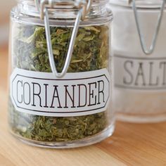 two jars filled with different types of herbs