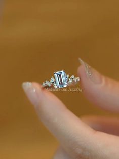 💎This engagement ring features a 1 carat emerald-cut aquamarine as the main stone, emitting a fresh and transparent blue light, just like the pure ocean, symbolizing loyalty and eternity.💙  👉 What does the fresh blue color of aquamarine remind you of most? Share your associations! 🌊  #aquamarinering #rectangularengagementring #emeraldcutring #1caratring #elegantjewelry #bluegemstonering Sapphire Emerald-cut Birthstone Ring In Fine Jewelry Style, Elegant Emerald-cut Birthstone Gemstones, Formal Emerald-cut Aquamarine Diamond Ring, Gold Emerald Cut Engagement Ring, Blue Emerald-cut Tanzanite Jewelry, Emerald-cut Aquamarine Rings For Gift, Aquamarine Wedding Ring, Diamond Accent Ring, Emerald Cut Rings
