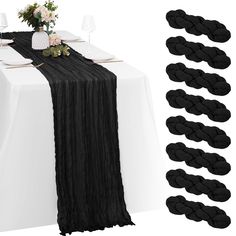 the table is set with black napkins and place settings