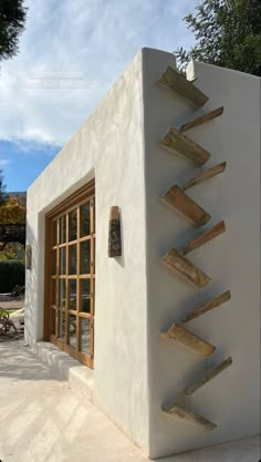 a white building with wooden stairs on the side