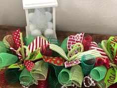 a close up of a wreath on a table near a small box with candy in it