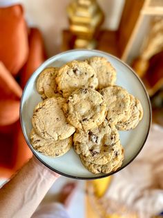 a person holding a plate full of cookies