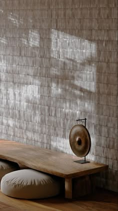 a wooden table sitting on top of a hard wood floor next to a white wall