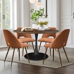 a dining room table with four chairs around it