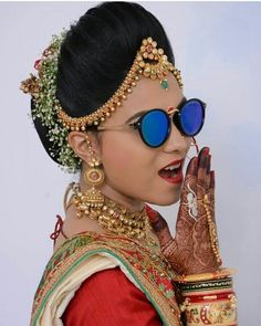 a woman with sunglasses and jewelry on her face