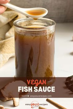 Brown broth in a clear glass jar with a spoon.