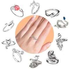 an assortment of rings on a woman's hand with the ring in front of her