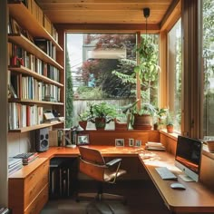 a home office with lots of bookshelves and plants in the window sill