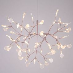 a chandelier with lights hanging from it's branches in the shape of a snowflake