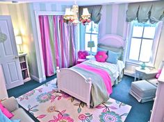 a bedroom decorated in pink, blue and green