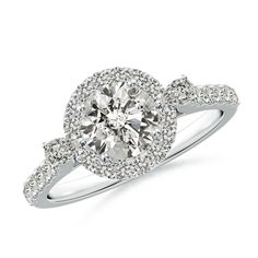 a diamond engagement ring with an oval halo setting and pave set diamonds around the band