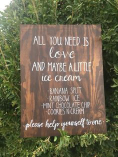 a wooden sign that says all you need is love and maybe a little ice cream