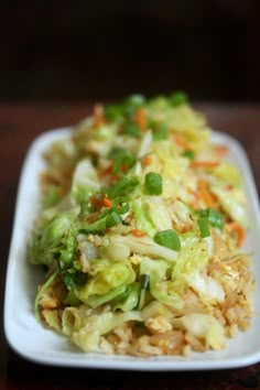 a white plate topped with rice and vegetables